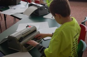 Student typing on Braille writer