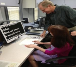 Staff demonstrating video magnifier to client